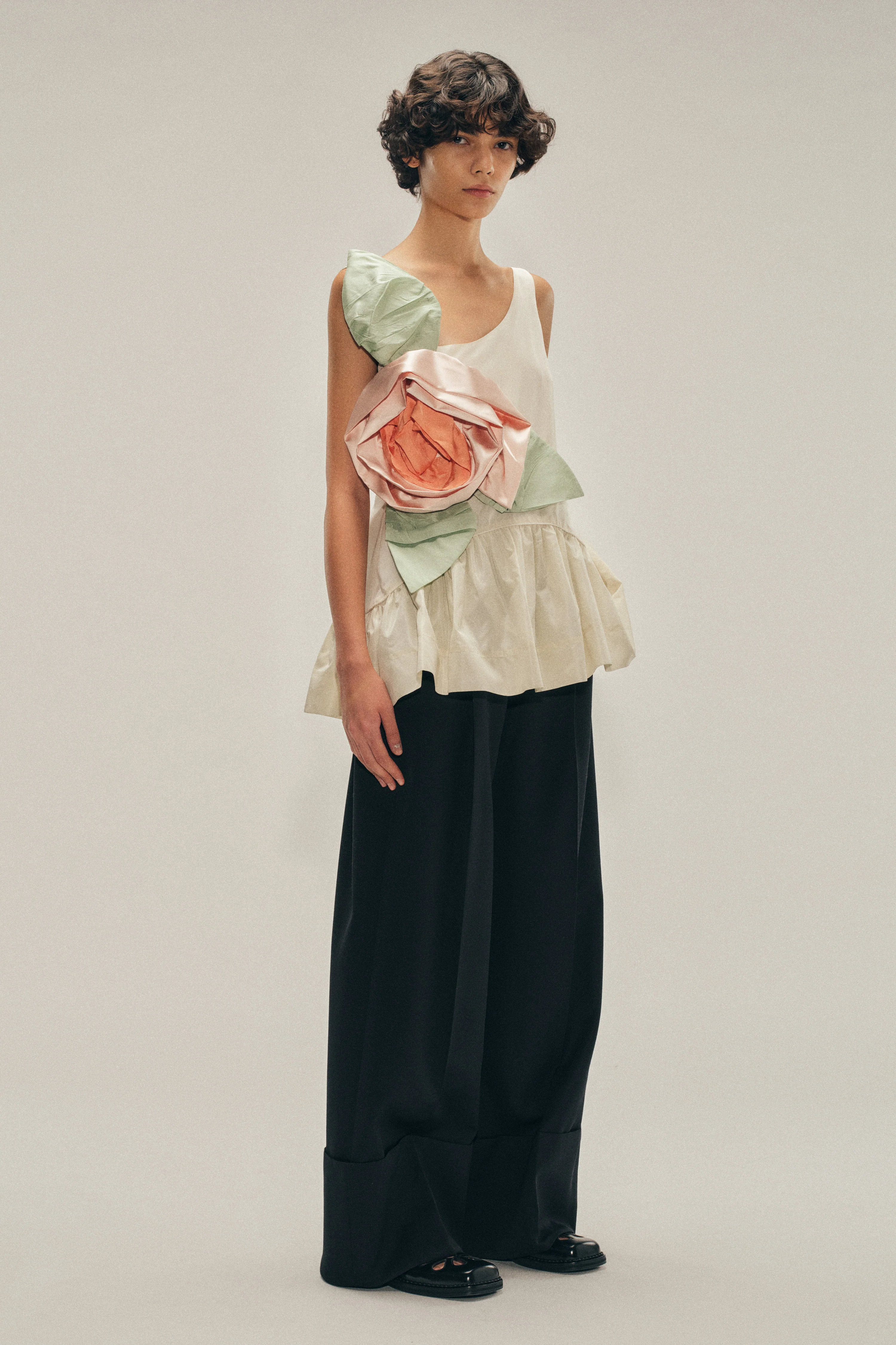 Pressed Rosette Tilted Neck Peplum Top